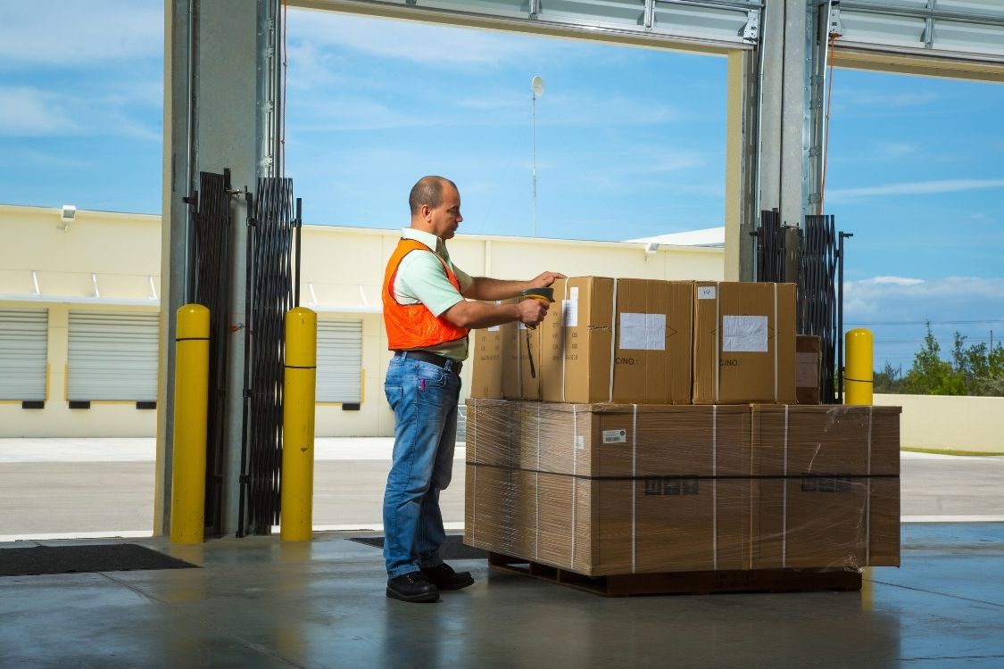 Container Loading & Unloading Warehouse worker scanning pallet of goods