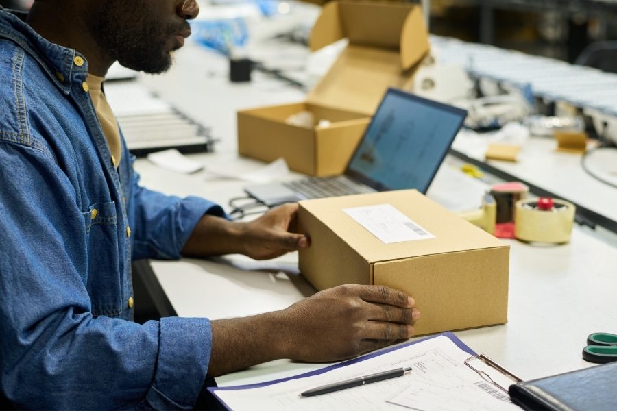 a man kitting a package
