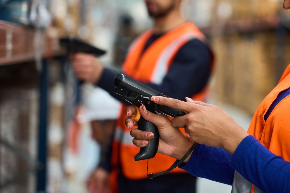 3pl Warehouse Management Systems - warehouse team scanning packages in storage to track within the inventory management system